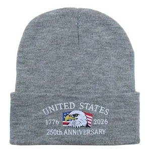 Detailed embroidery of US Marine Corps 250th Anniversary logo on a gray knit beanie