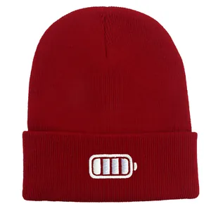 Close-up of red ribbed knit beanie featuring a white battery status embroidery detail