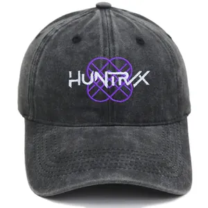 Detail of HUNTRVX embroidery on washed dark grey vintage cotton baseball cap texture