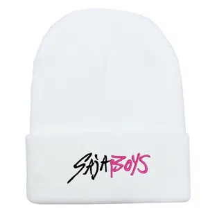 Detailed macro view of SAJA BOYS embroidery on white knitted cuff beanie hat