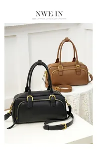 Detail view of retro bowling bags in black and brown with gold hardware on lace table