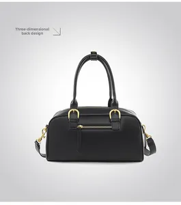 Detail view of the black bowling bag back zipper pocket and golden hardware accents