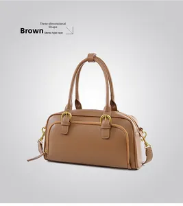 Detailed front view of brown leather bowling bag with gold hardware and shoulder strap