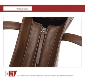 Gros plan du sac cabas en cuir marron avec fermeture éclair en métal argenté et texture durable