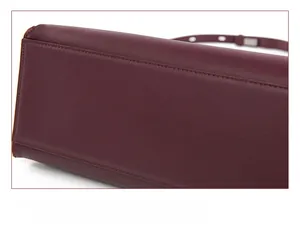 Detailed close-up showing precision stitching and premium leather texture of the red backpack