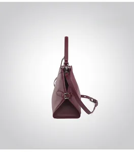 Side view of structured burgundy leather tote bag with silver hardware and shoulder strap