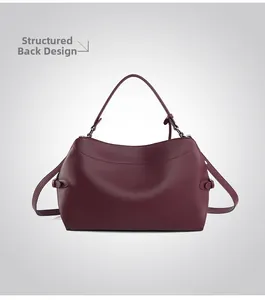 Back view of wine red leather tote bag showing structured shape and sleek metal buckles