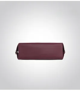 Detail view of the rectangular bottom of the burgundy leather handbag with neat stitching