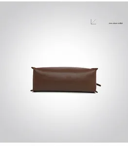 Détail du fond plat d'un cabas en cuir marron foncé avec coutures de renfort robustes