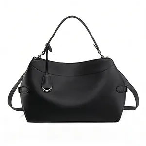 Close-up of matte black leather handbag with silver hardware and detailed stitching