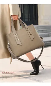 Detail view of khaki TOGO leather tote bag with metal bar handle and textured finish