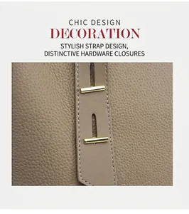 Macro detail of TOGO leather tote with stitching and golden hardware buckles