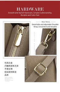 Detail of golden metal hardware and taupe lychee grain leather on tote handbag