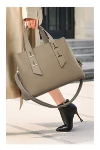 Close-up of elephant gray litchi grain leather tote with gold hardware details