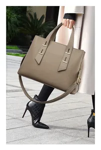 Detail view of taupe Togo leather tote bag with grainy texture and gold hardware details