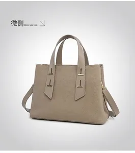 Detail view of the side profile showing structured taupe Togo leather and gold hardware