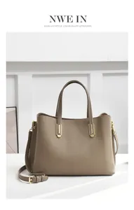Detail of lychee pattern leather tote bag with gold hardware and adjustable strap