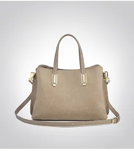Macro shot of back view taupe lychee pattern leather tote bag with gold metal hardware