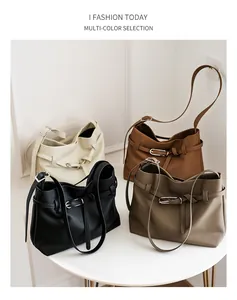 Minimalist leather tote bags in four colors displayed on a white table for daily style