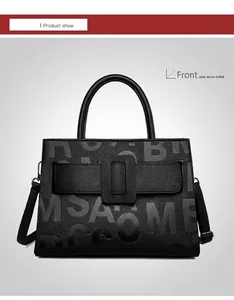 Detailed front view of black litchi grain leather tote bag with gray letter prints
