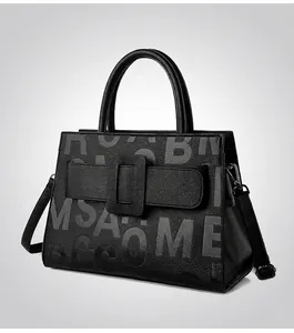 Detail view of black lychee grain leather tote bag with stylish buckle and letter print