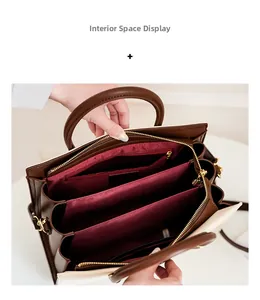 Detailed interior of color-block tote bag showing multiple compartments and red lining