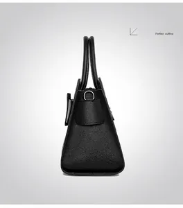 Close-up of black litchi pattern leather tote bag with side triangle outline detail