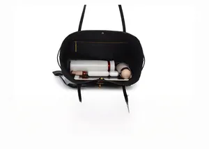 Macro view of the black tote bag interior showing large capacity for daily items