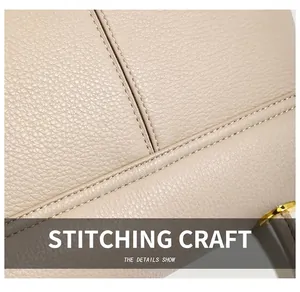 Detail of high-quality stitching and lychee grain leather on a beige shoulder bag