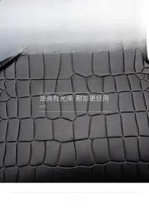 Macro shot of black crocodile embossed PU leather featuring waterproof and wear-resistant texture