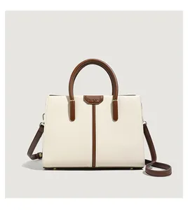 Detail of contrast color tote bag with Muse Bag logo and adjustable shoulder strap