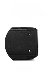 Detail showing durable metal bottom studs and textured leather on a black tote bag