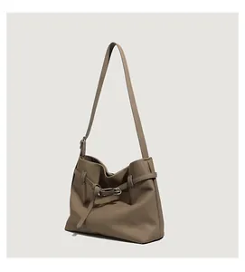 Detailed side view of dark khaki tote bag with pebbled leather texture and silver buckle