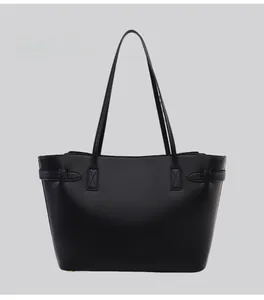 Back view of a minimalist black leather tote bag featuring a matte textured finish