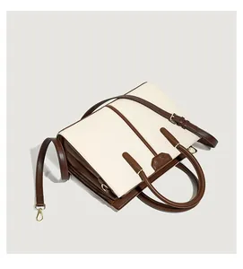 Detailed top view of the two-tone leather tote bag with shoulder strap and gold hardware