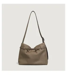 Detail of minimalist tote bag showing lychee grain leather texture and adjustable strap