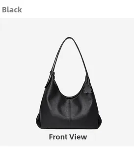 Detailed front view of black litchi grain leather tote bag with cute bear charm