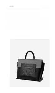 Detail of black tote bag showing crocodile embossing and white hexagonal mesh texture
