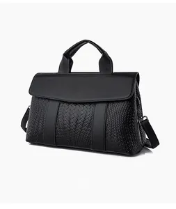 Detailed view of woven texture and litchi pattern on this black tote bag for women