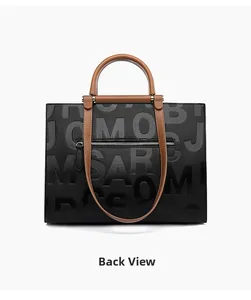 Back view of the black and brown tote bag with embossed letters and a zipper pocket