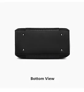 Detailed bottom view of black tote bag showing metal feet and crocodile embossed leather