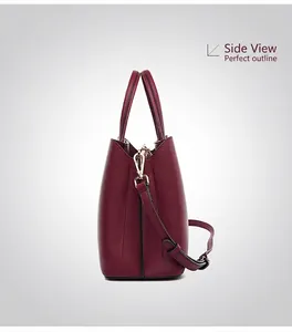 Detail of burgundy lychee leather tote with adjustable strap and structured side profile