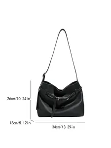 Minimalist black pebbled leather tote bag with silver buckle and 34cm dimensions