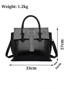 Women's black faux leather tote bag with crocodile and honeycomb textures and gold hardware