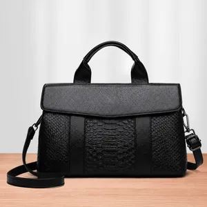 Elegant black leather handbag with crocodile texture detail and adjustable strap