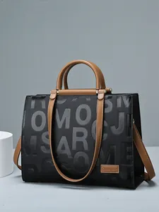 Chic black and brown tote bag with embossed letters and adjustable shoulder strap