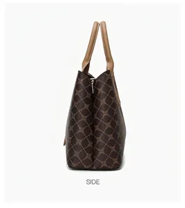 Zijaanzicht van de grote vintage monogram tote bag met beige handvaten en textuur