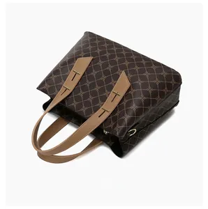 Dettaglio della borsa tote con motivi geometrici marroni e manici in pelle