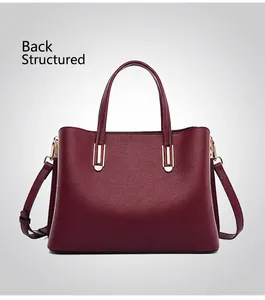 Rear view of burgundy faux leather handbag showing a solid shape and gold hardware