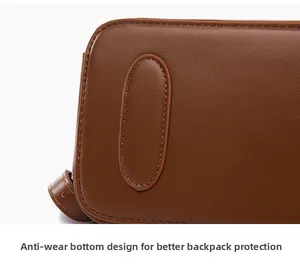 Macro shot of wear-resistant bottom pad on dark brown leather backpack for protection